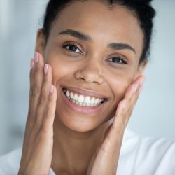 A Person Smiling And Talking On The Phone