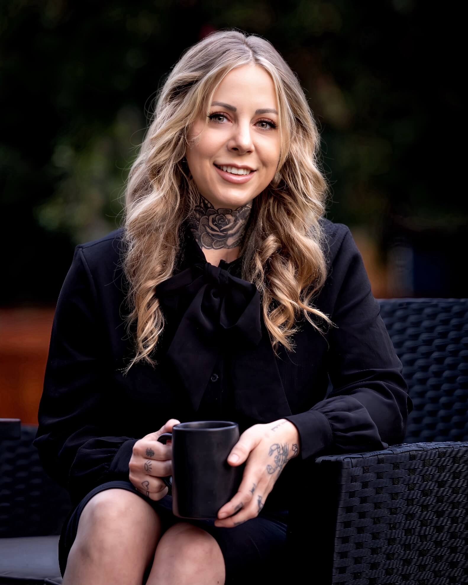 a woman sitting on a bench talking on a cell phone